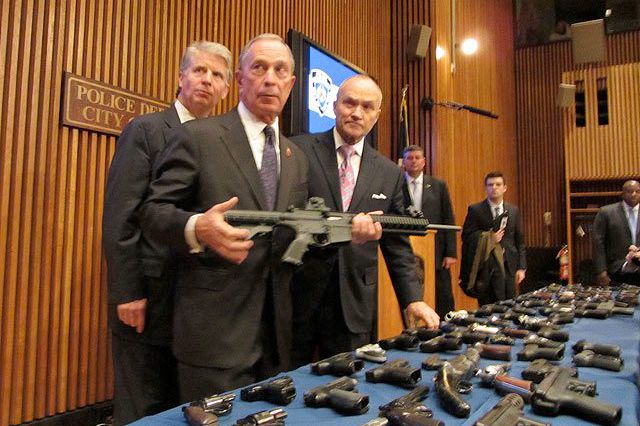 Mayor Bloomberg, with Manhattan DA Cy Vance and Commissioner Ray Kelly, holding an assault rifle after a gun bust last week